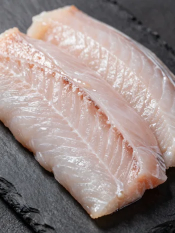 Fileuri proaspete de anghilă cu condimente pe un tocător de lemn